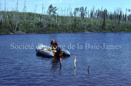 Canoe man with boat at Chibougamau River.