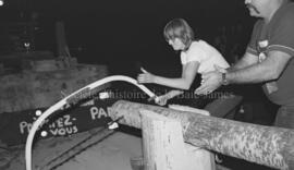 Une personne sciant une bûche lors du festival de bûcheron à Lebel-sur-Quévillon